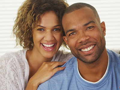 The image depicts a man and a woman sharing a joyful moment together.
